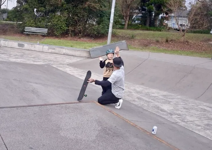 Skatemate coach high-fiving a young skater at a Port Stephens skatepark